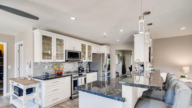 A modern kitchen with white cabinetry, granite countertops, and stainless steel appliances. - Top Choice for Guests, Golf, HPool~Spa, Bachelorettes, Quick Walk for Groceries (Scottsdale)