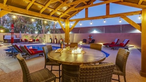 An outdoor patio with a pool, lounge chairs, and a fire pit. - Top Choice for Guests, Golf, HPool~Spa, Bachelorettes, Quick Walk for Groceries (Scottsdale)