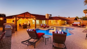 A poolside area with lounge chairs, a barbecue grill, and a covered patio. - Top Choice for Guests, Golf, HPool~Spa, Bachelorettes, Quick Walk for Groceries (Scottsdale)