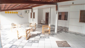 A room with a tiled floor, wooden furniture, and barred windows. - HOUSE ON FRENCH BEACH (Praia do Francês)