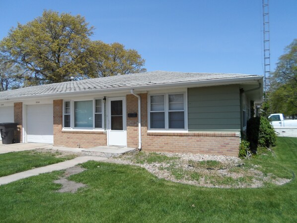 A single-story house with a brick facade, a covered porch, and a garage. - 1950's Retro Ranch. Conveniently located off Highway 281 (Grand Island)