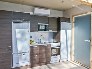 A compact kitchen with a refrigerator, stove, sink, and microwave. - Topstar lakeland viitasaari by Interhome (Viitasaari)