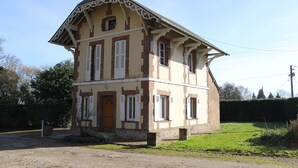 A two-story building with a gabled roof and decorative trim. - Domain House - Landin Castle (LE LANDIN)