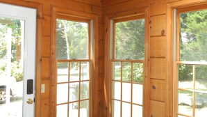 A wooden interior with large windows, a door, and a brick base. - PERFECT LISTING !!! House in Historic Chickamauga (Chickamauga)