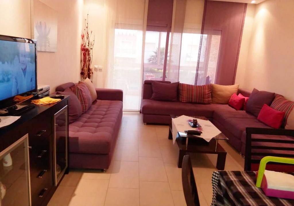 A living room with two sofas, a coffee table, and a TV.