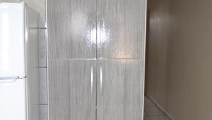 A kitchen with a grey cabinet and a white refrigerator.