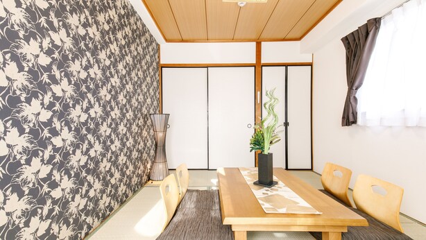 A traditional Japanese-style room with tatami flooring, a low wooden table, and a shoji screen door. - Japanese Modern Room Tenma (Osaka)