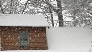 A wooden cabin with a snow-covered roof and a porch. - Game Room, Fireplace and pit, very private, a little taste of heaven! (Dahlonega)