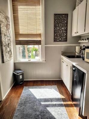 Fridge, microwave, coffee/tea maker, cookware/dishes/utensils