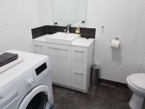 Shower, hair dryer, towels, toilet paper