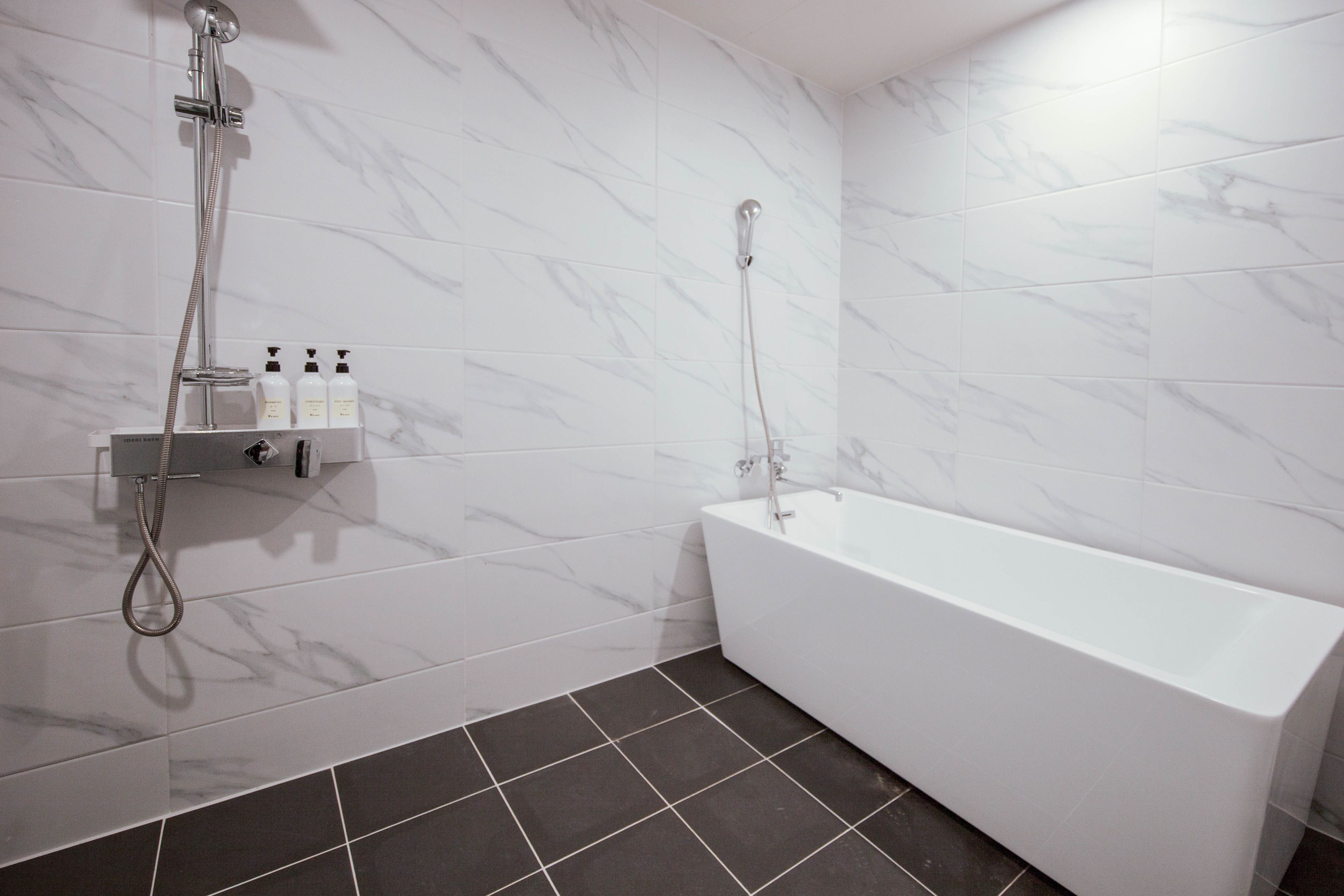 premier deluxe king room | bathroom | separate bathtub and shower, deep-soaking bathtub, designer toiletries