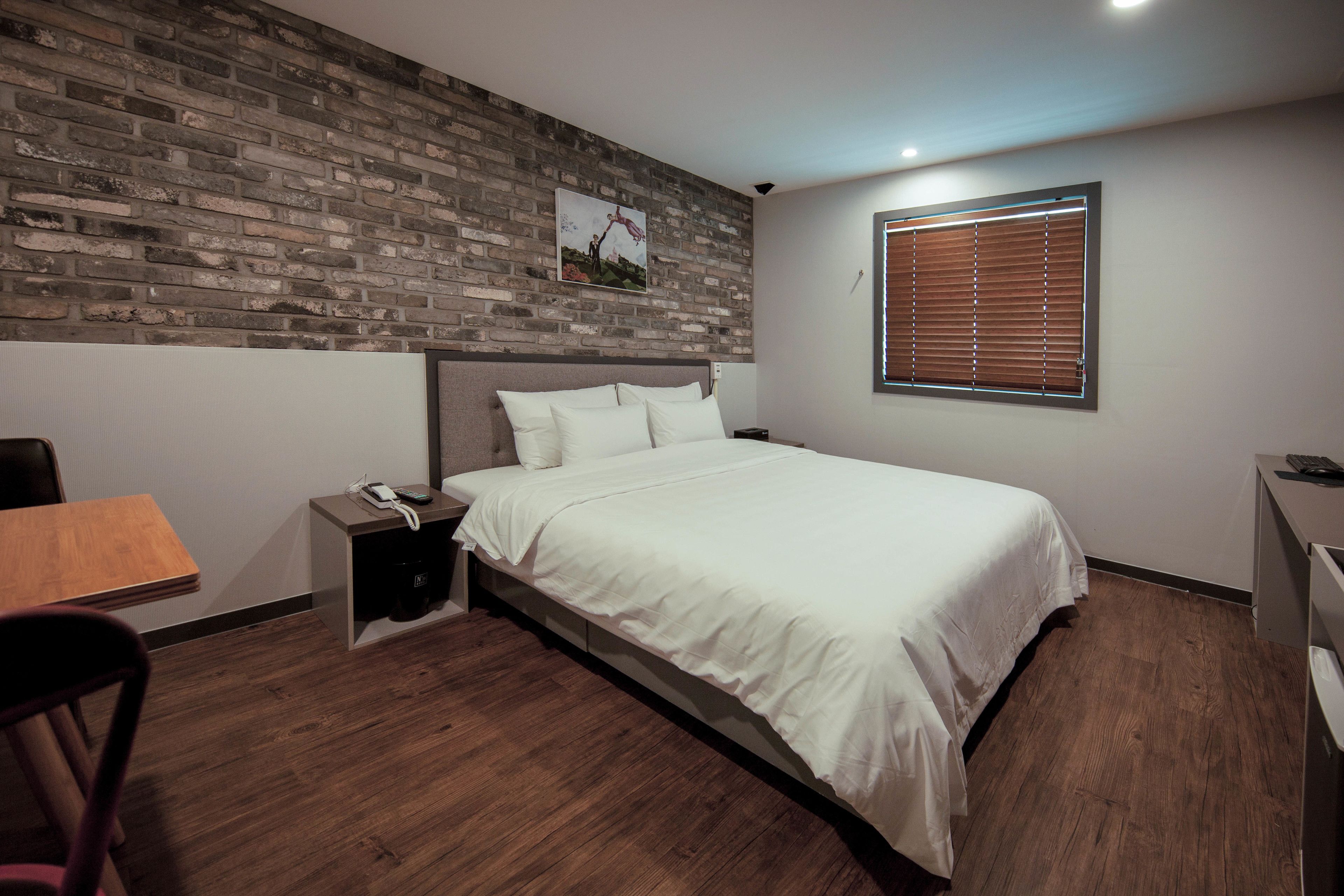 deluxe king room | premium bedding, desk, laptop workspace, blackout curtains