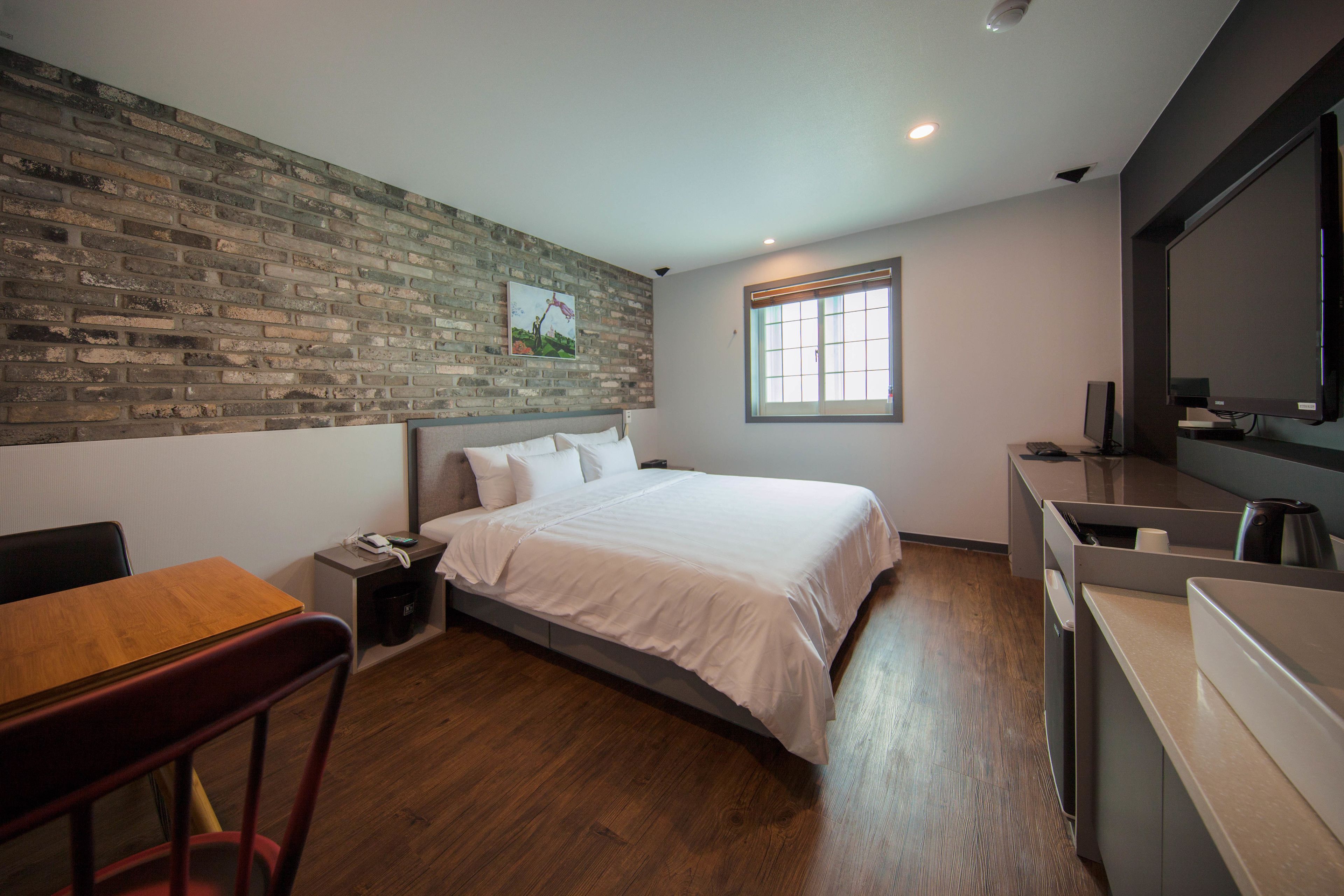 deluxe king room | premium bedding, desk, laptop workspace, blackout curtains