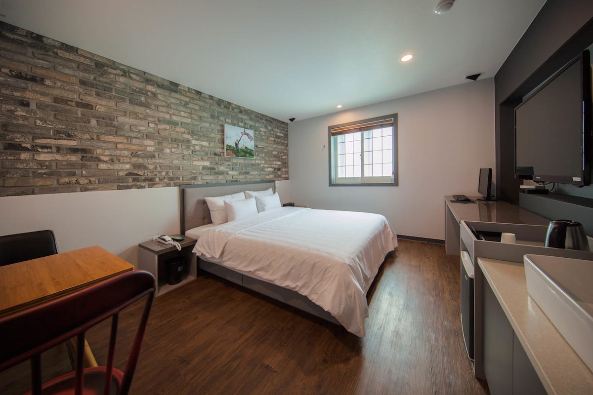 deluxe king room | premium bedding, desk, laptop workspace, blackout curtains