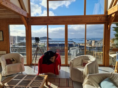 Recent wood-frame villa with panoramic view of the port and islands.