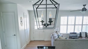 A dining area with a wooden table, chairs, and a potted plant.
