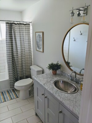 A bathroom with a toilet, sink, and shower area. - Villa K - Beautiful Home - Old Town Scottsdale Vacation Rental by Zoomie Brokers (Scottsdale)