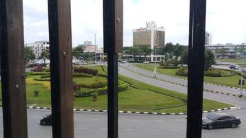A view of a cityscape with a modern building labeled "Prudential" and a well-maintained road with greenery and a roundabout.