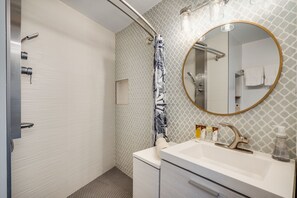 Shower, rainfall showerhead, hair dryer, towels