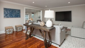 A living room with a wooden table, a white lamp, and a grey sofa. - Spacious & Gracious 3 Bedrooms, 2 Full Baths Ranch Living in central location!!! (Andover)