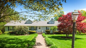 A two-story house with a front lawn, a pathway leading to the entrance, and a street lamp. - Spacious & Gracious 3 Bedrooms, 2 Full Baths Ranch Living in central location!!! (Andover)
