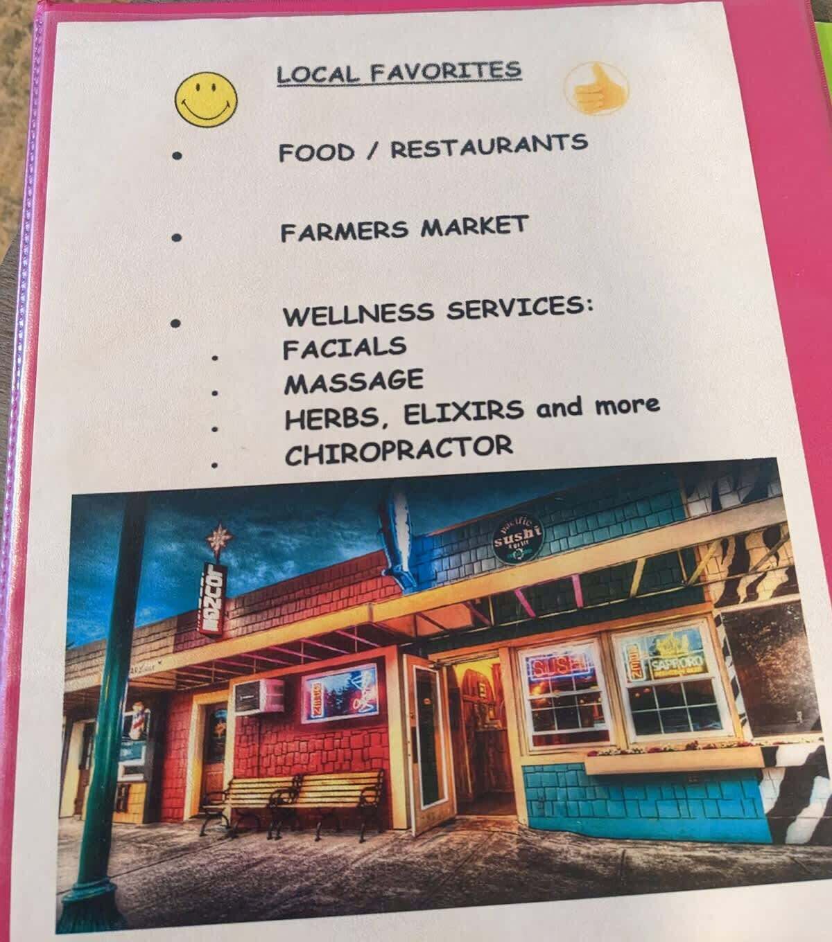 Bordje met lokale aanbevelingen voor eten/restaurants, een boerenmarkt en wellnessdiensten zoals gezichtsbehandelingen, massages, kruiden, elixers en een chiropractor.