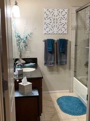 Combined shower/tub, hair dryer, towels, soap