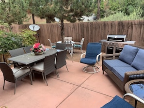 Enjoy al fresco dining and relaxation in this outdoor patio with a seating area, grill, and satellite TV.