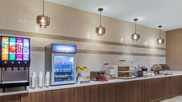 A self-service beverage station with a refrigerated drink dispenser and a coffee machine.