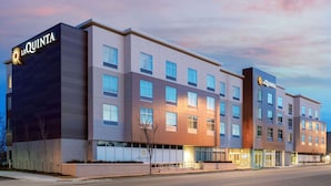 A multi-story hotel with a modern facade, featuring the brand name 'La Quinta' prominently displayed on the building.