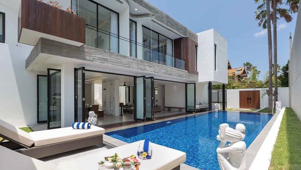 A modern two-story house with a swimming pool, outdoor seating, and a well-maintained lawn. - Villa Damar Canggu by Nagisa Bali (Canggu)