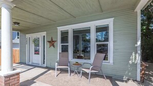 A house with a porch, two chairs, a small table, and a star decoration. - Charming Home | Near Spokane City Center (Spokane)