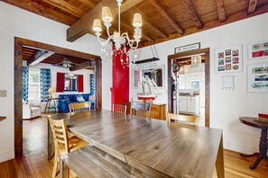 Enjoy dining and socializing in this inviting space with a large table and comfortable seating.