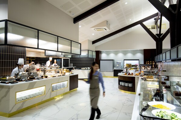 A modern kitchen with marble flooring, stainless steel appliances, and a buffet area with various food items. - Mt Cook Lodge & Motels (Mount Cook)