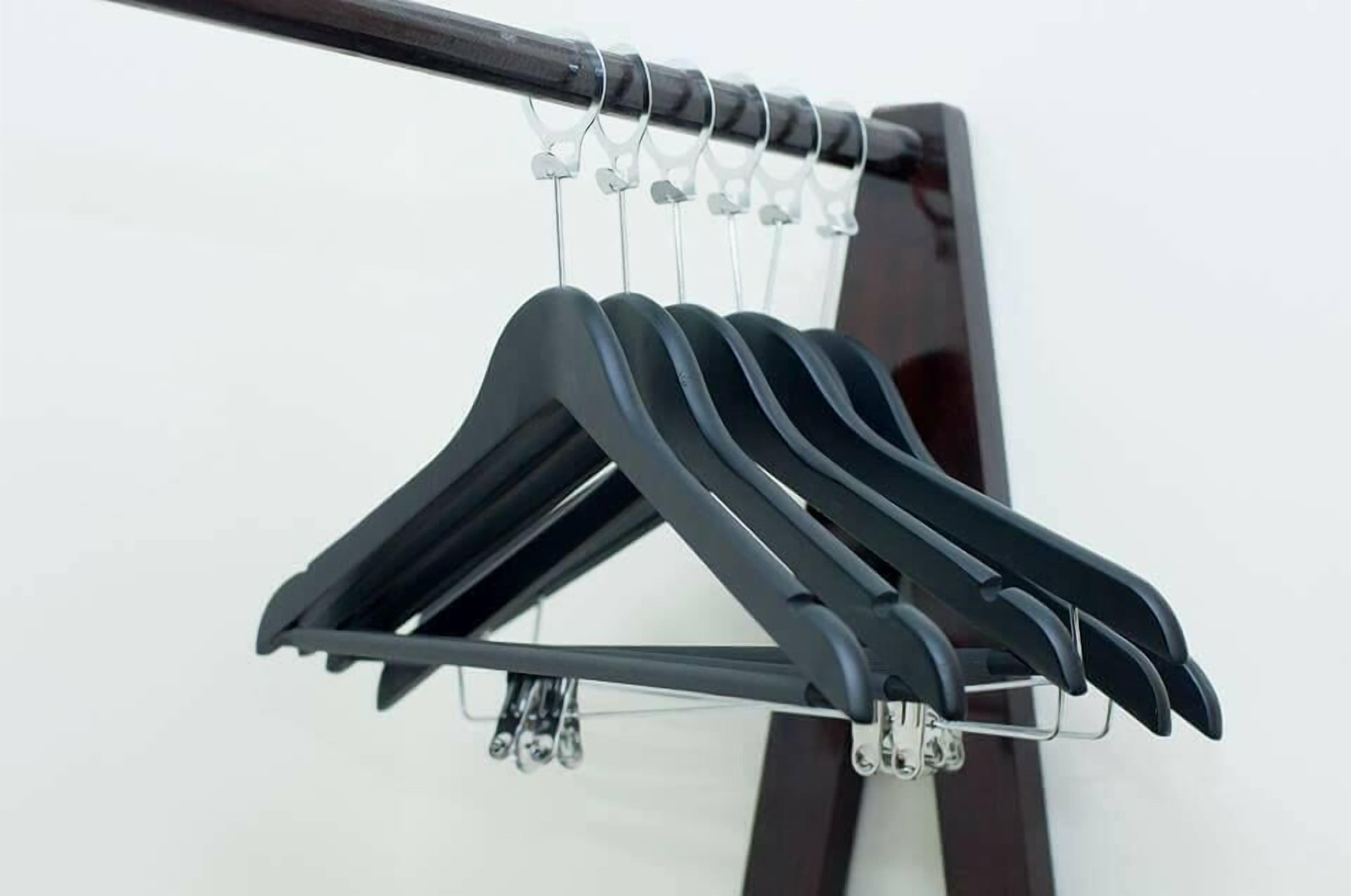 A black hanger rack with multiple hangers.