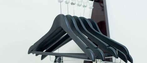 A black hanger rack with multiple hangers.