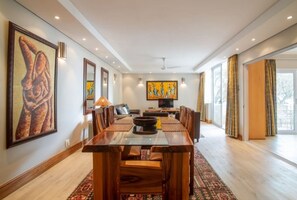 Enjoy meals in this dining area with a long table and comfortable seating for all.