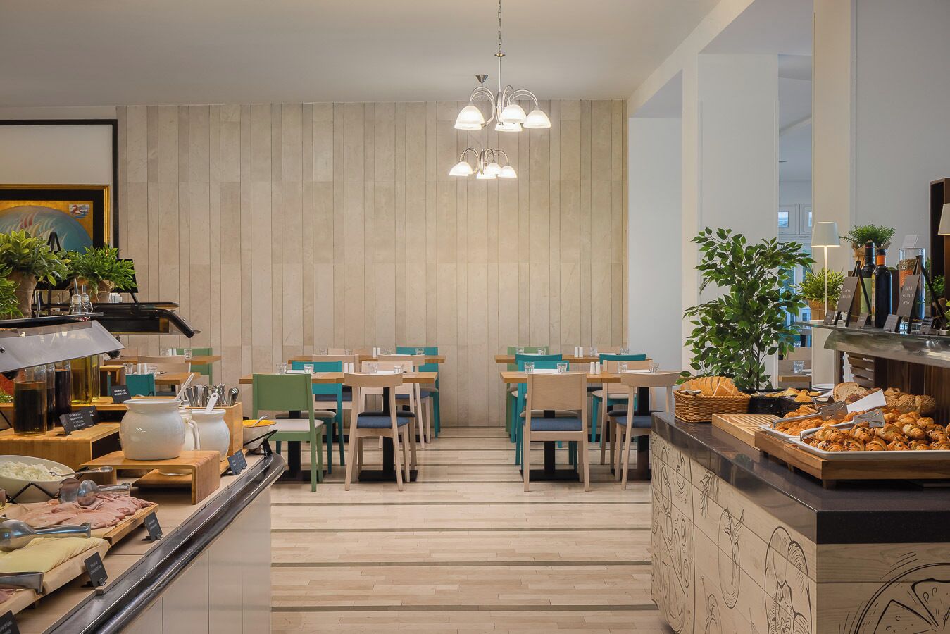 A modern cafe with wooden tables and chairs, a variety of food items displayed, and a minimalist decor.