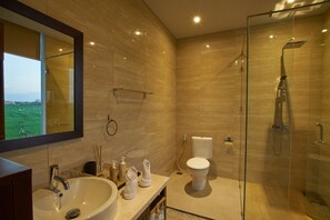A modern bathroom with a large sink, toilet, and glass-enclosed shower. - The Araya Villas Cemagi Beach (Cemagi)