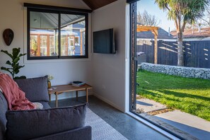 TV, books, printers - Roker Street Retreat - Contemporary Kiwi Styled Studio (Christchurch)