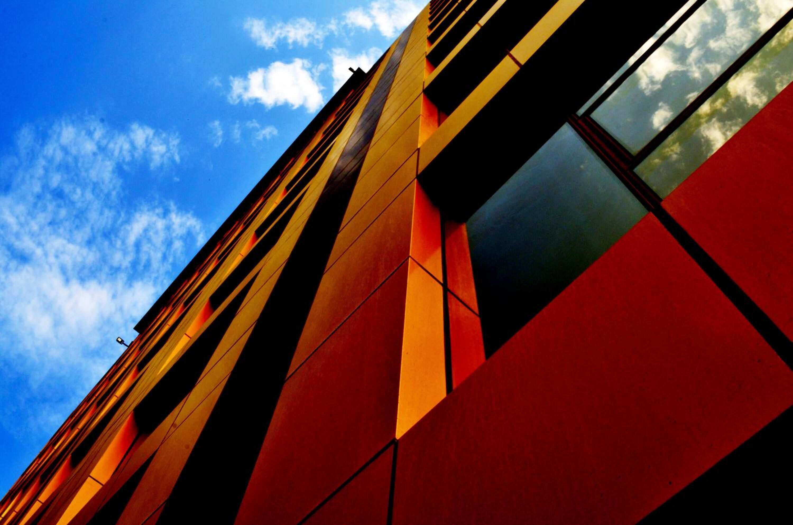 A modern building with a geometric facade and large windows.
