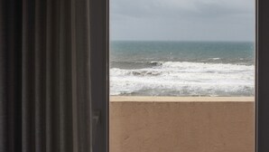 A view of the ocean through a window with curtains. -  THE ONE Grand Hotel da Póvoa 4 (Povoa De Varzim)