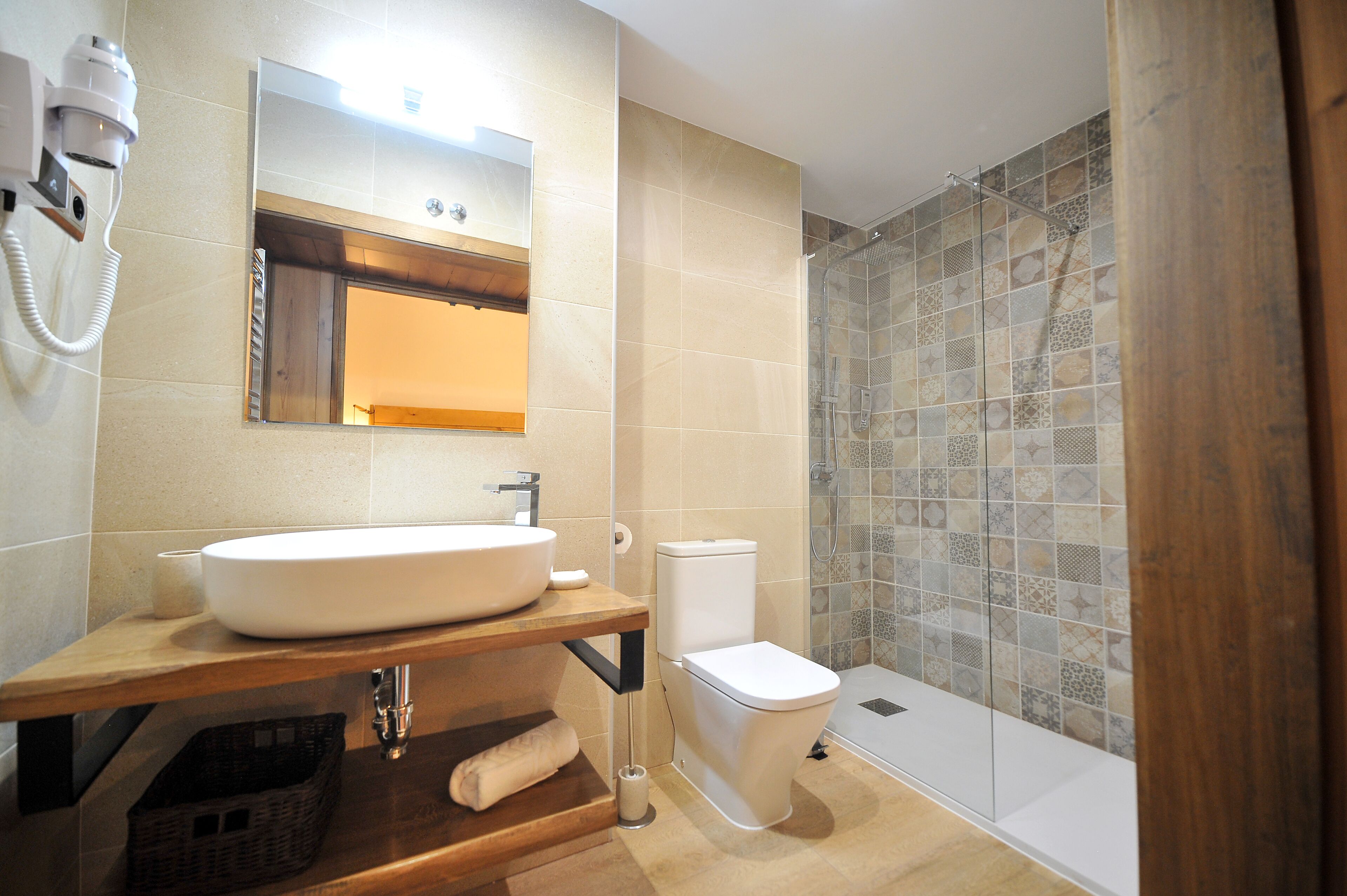 A modern bathroom with a large sink, toilet, and shower area.