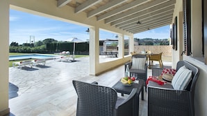 A covered patio area with outdoor furniture, a pool, and a view of the surrounding landscape. - VILLA MADRAVE - FAMILIES AND FRIENDS (Pollensa)