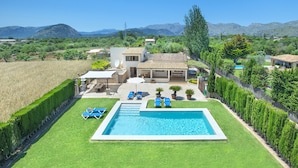 A residential property with a swimming pool, a patio with lounge chairs, and a view of the surrounding landscape. - VILLA MADRAVE - FAMILIES AND FRIENDS (Pollensa)