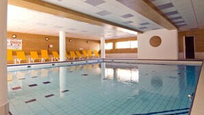An indoor swimming pool with tiled floors and walls, yellow chairs along the side, and a wooden ceiling with recessed lighting. - Wifi, ski-in/ski-out & foot of the slopes, swimming pool, balcony, 40-50m², Les Orres (Les Orres)