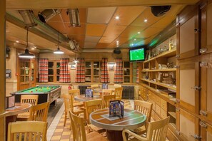 Relax and socialize in this inviting space with a pool table, comfortable seating, and ample storage.