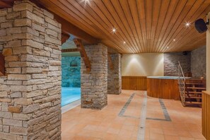 Relax by the pool or socialize at the bar in this inviting space with a high ceiling and arched opening.