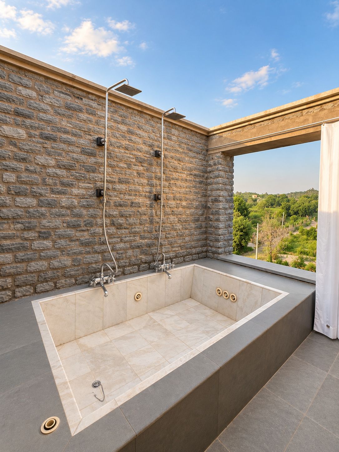 Une salle de bain extérieure moderne avec un mur en pierre, une grande baignoire et une vue sur la campagne.