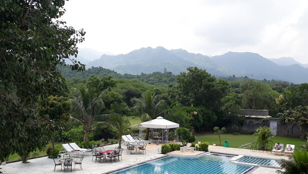 A pool area with lounge chairs, a small pool, and a gazebo. - King's Abode Ranakpur (Desuri)